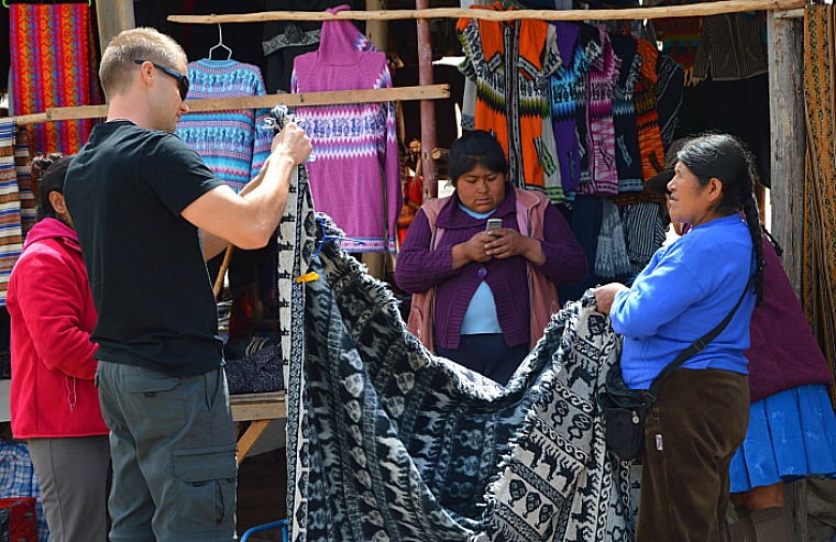 Negotiating for an alpaca blanket. peru sacred valley