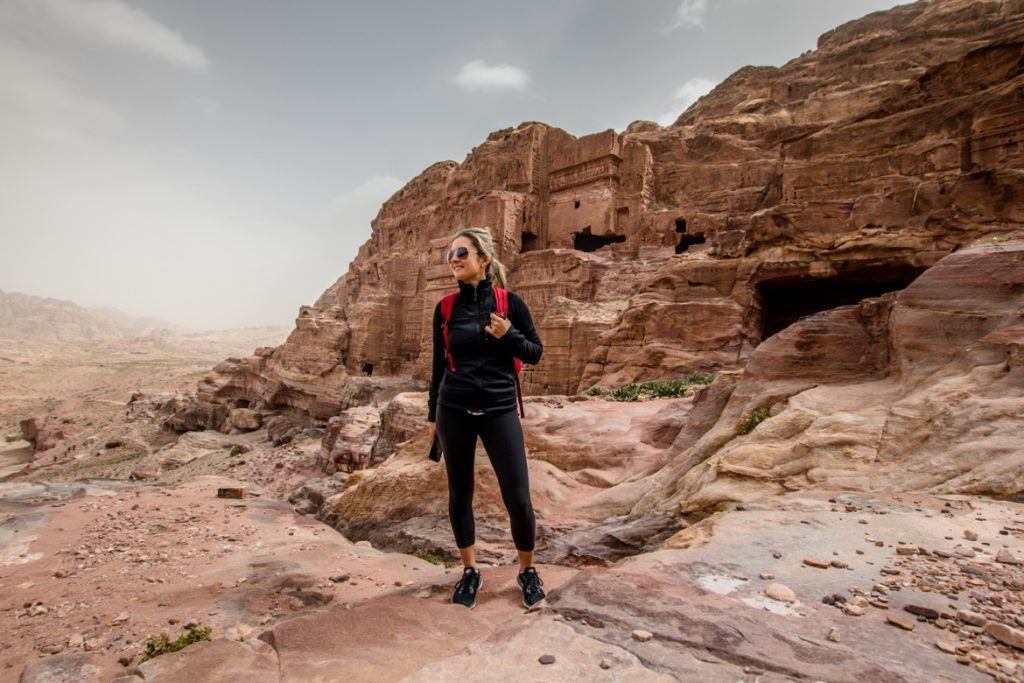 A woman on a tour visiting Petra, Jordan